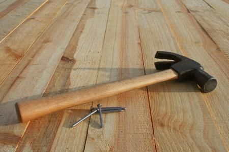 Hammer and nails on wooden planks.
