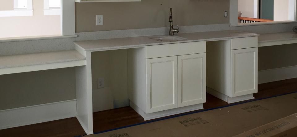 White kitchen cabinets and countertops in a room.