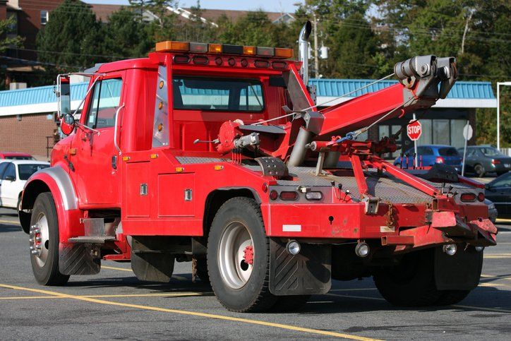 Tow Truck Towing A Broken Down Car — Covington, LA — Lester's Body Shop