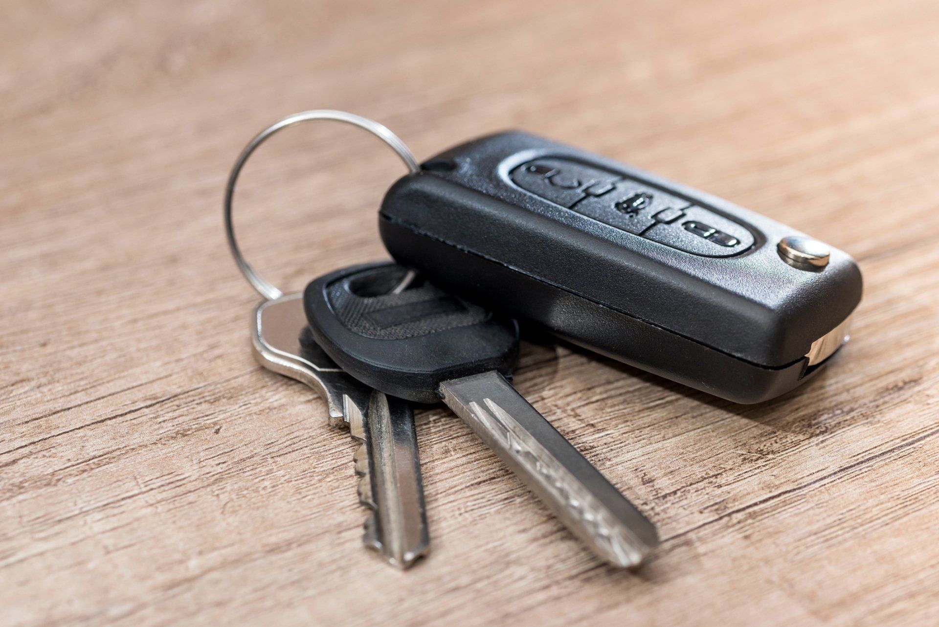 Black Car Key On Wooden Desk — Covington, LA — Lester's Body Shop