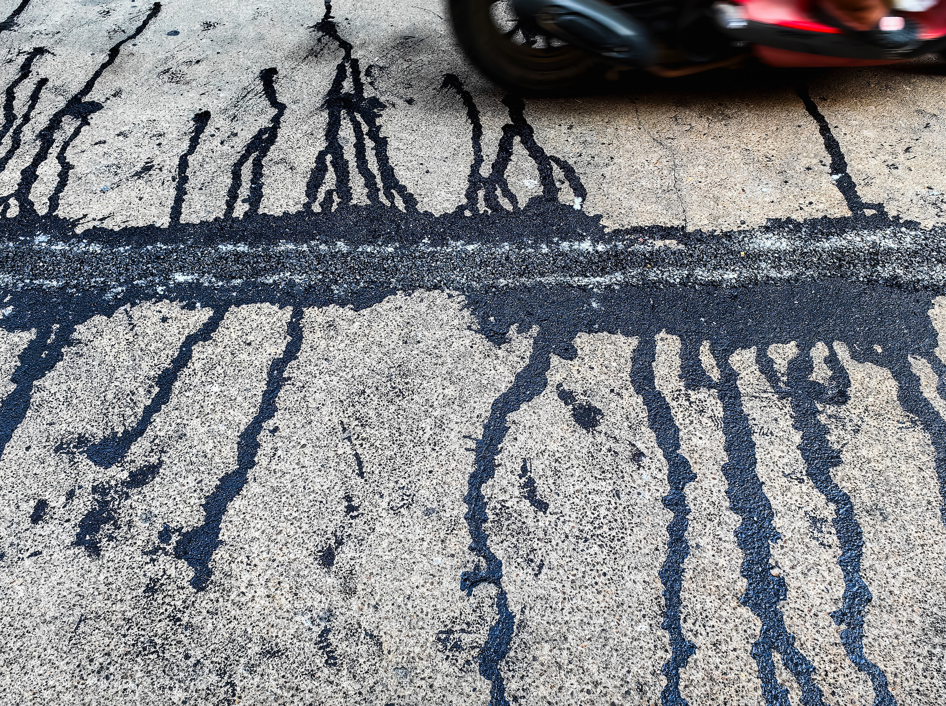 There is a yellow line on the road in front of a house.