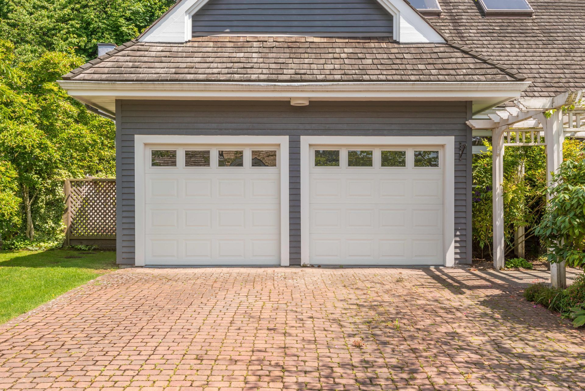 Garage Door Company installing modern double garage doors on a residential home. Garage Door Company installing modern double garage doors on a residential home.