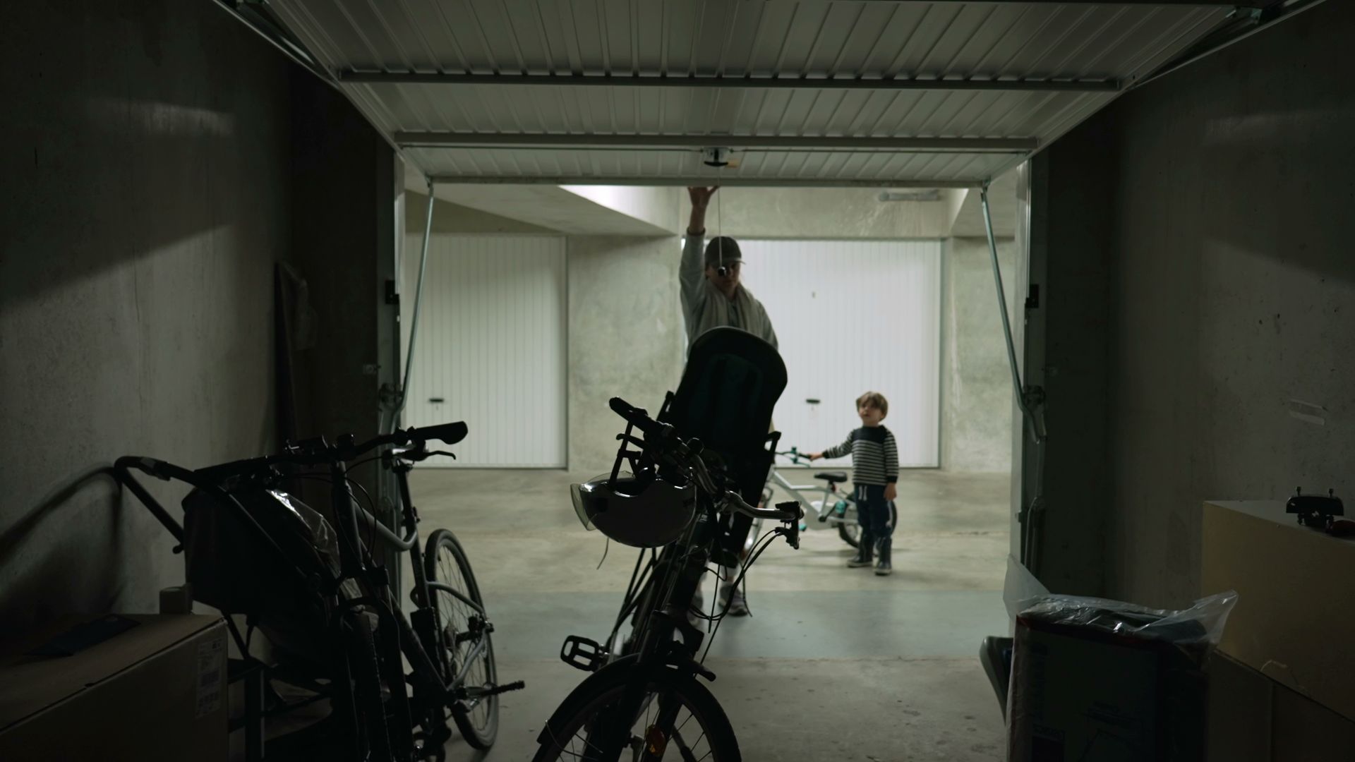 Person opening garage door and taking bicycle for a ride.