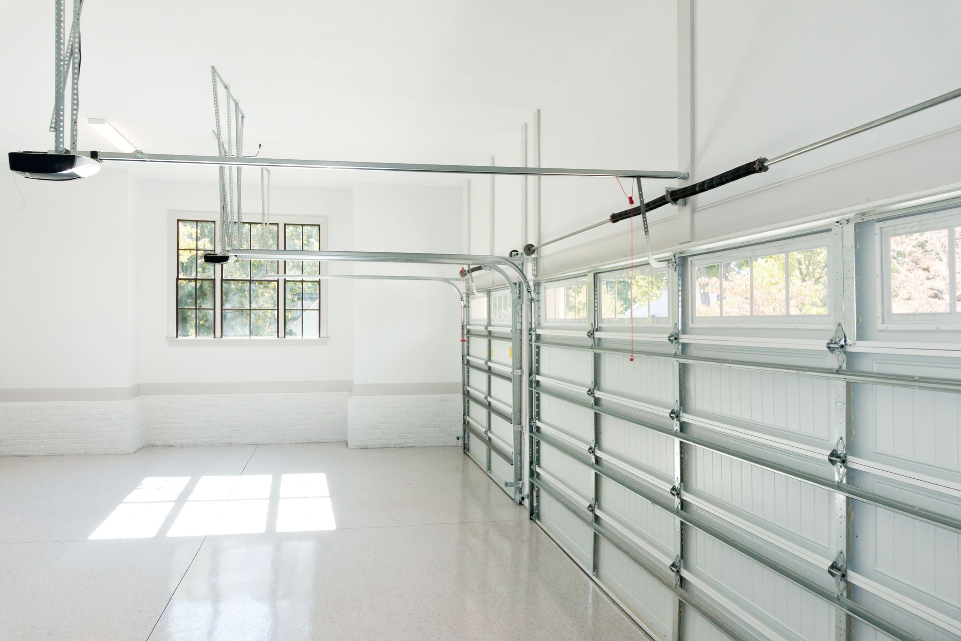 Garage System Spring Replacement for overhead garage door mechanism inside residential garage Garage System Spring Replacement for overhead garage door mechanism inside residential garage
