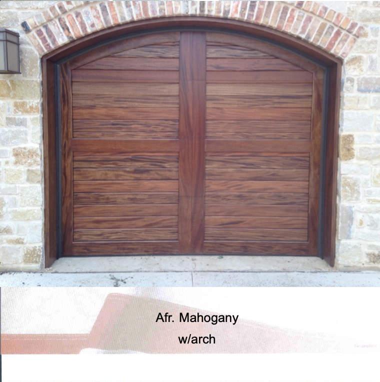 A dark African mahogany wood garage door with a horizontal plank design and a brick-accented arched frame.