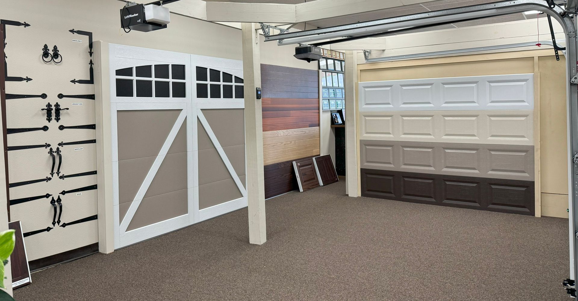 Garage door samples displayed in a showroom. Various styles and colors are showcased.