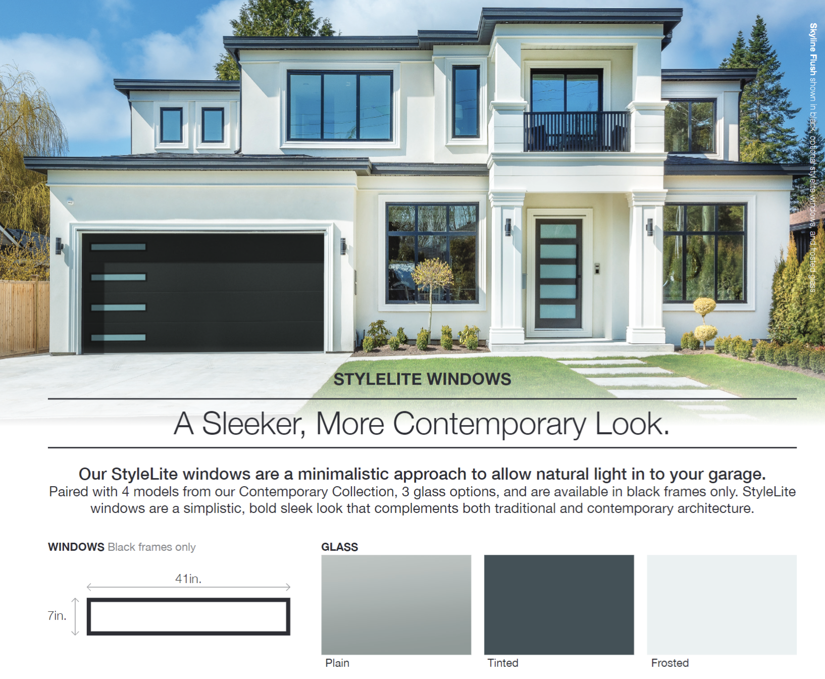 Modern white house with black garage door, windows.