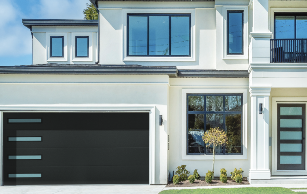 A modern, white two-story house with a black garage door, dark-framed windows, and a matching front door.