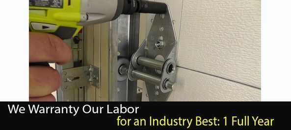 A hand using a power drill on a garage door hinge. Text: We Warranty Our Labor for an Industry Best: 1 Full Year. A hand using a power drill on a garage door hinge. Text: We Warranty Our Labor for an Industry Best: 1 Full Year.
