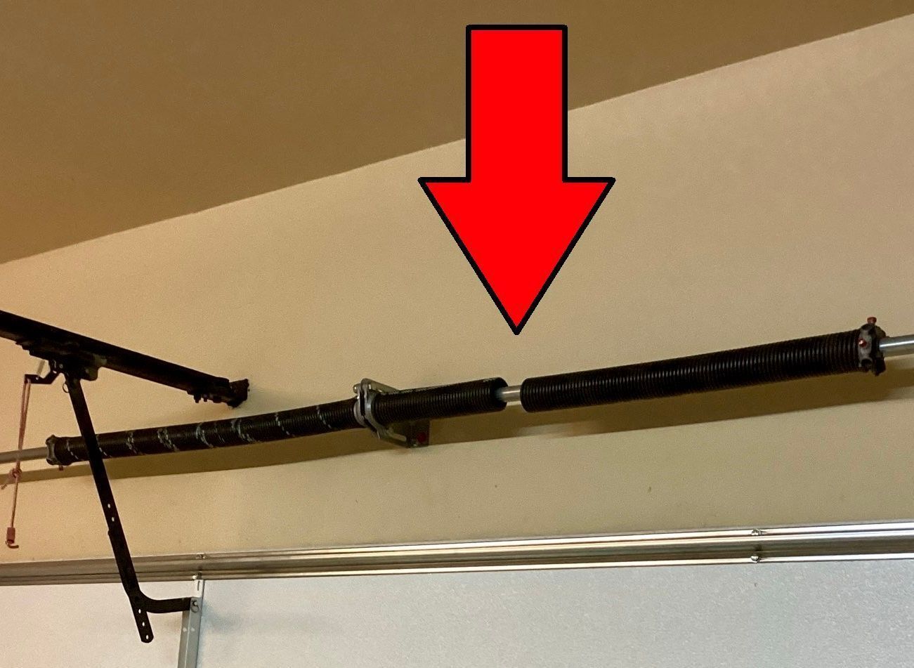 Sword mounted on a wall, with a red arrow pointing to the hilt.