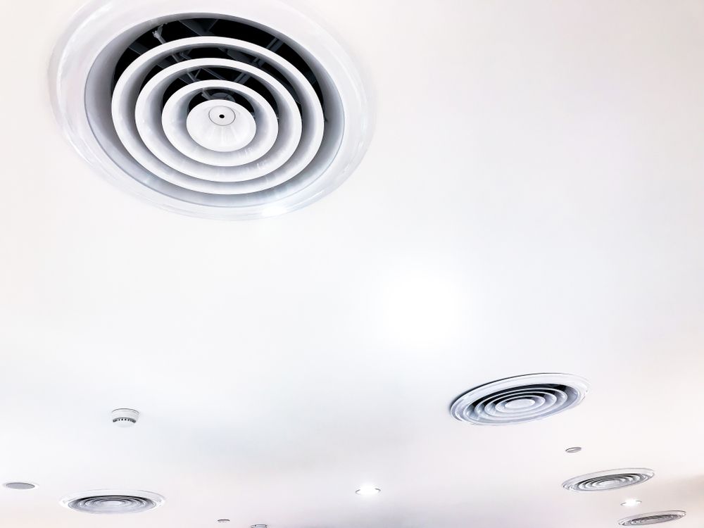 White ceiling with several circular air vents. — Don Hall Air Conditioning & Electrical in Smithfield, QLD