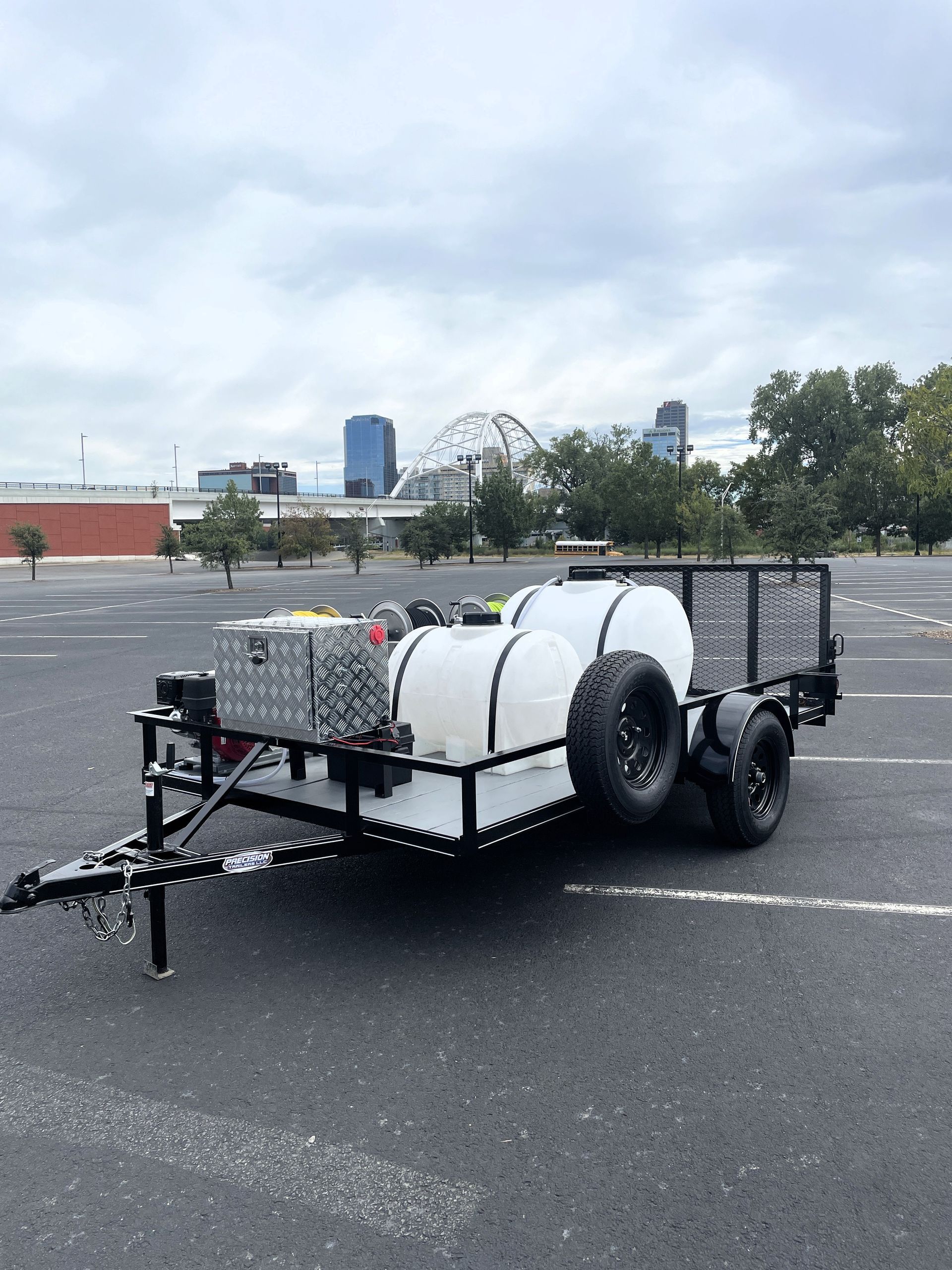 A trailer with a tank on it is parked in a parking lot.