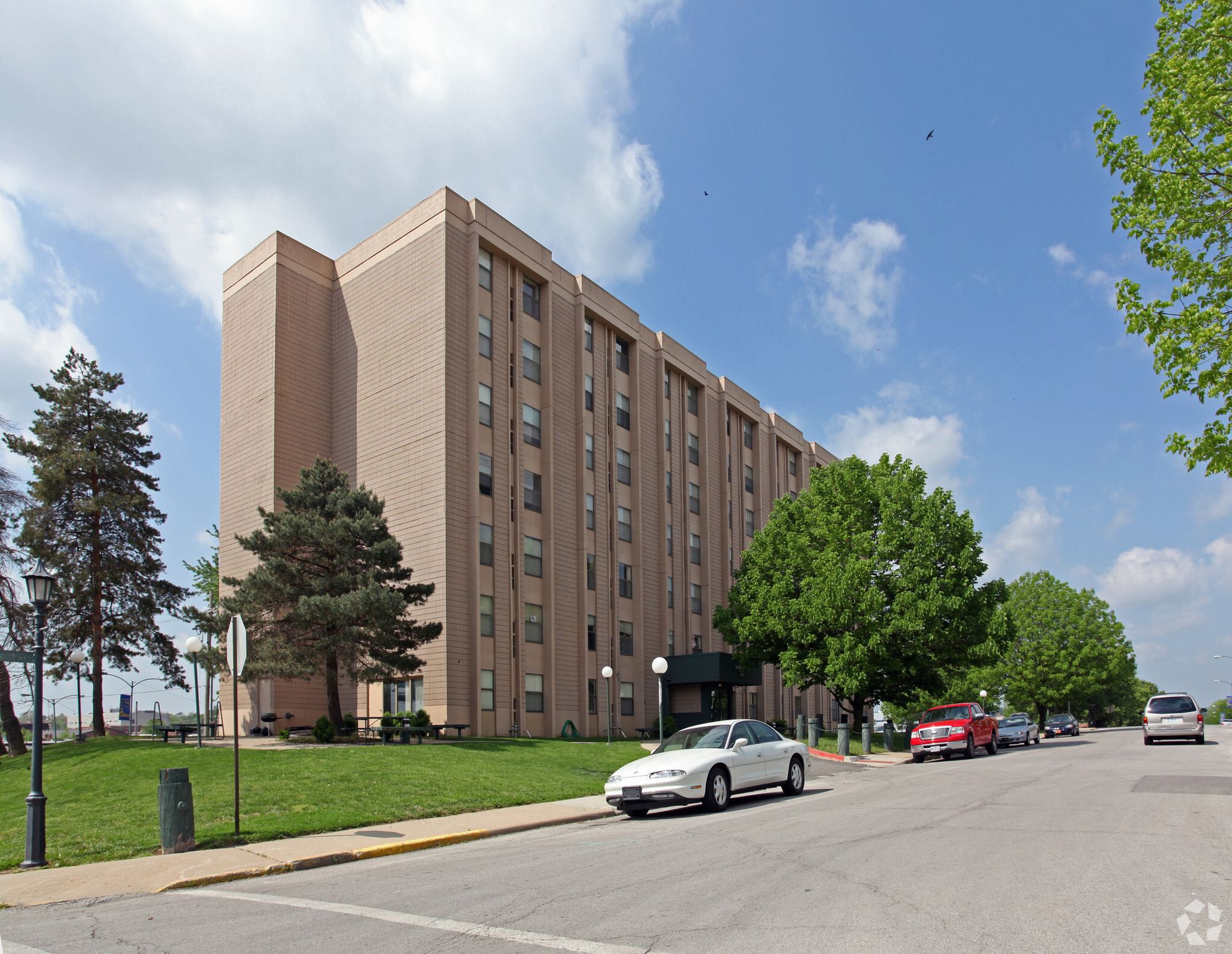 A large building with cars parked in front of it