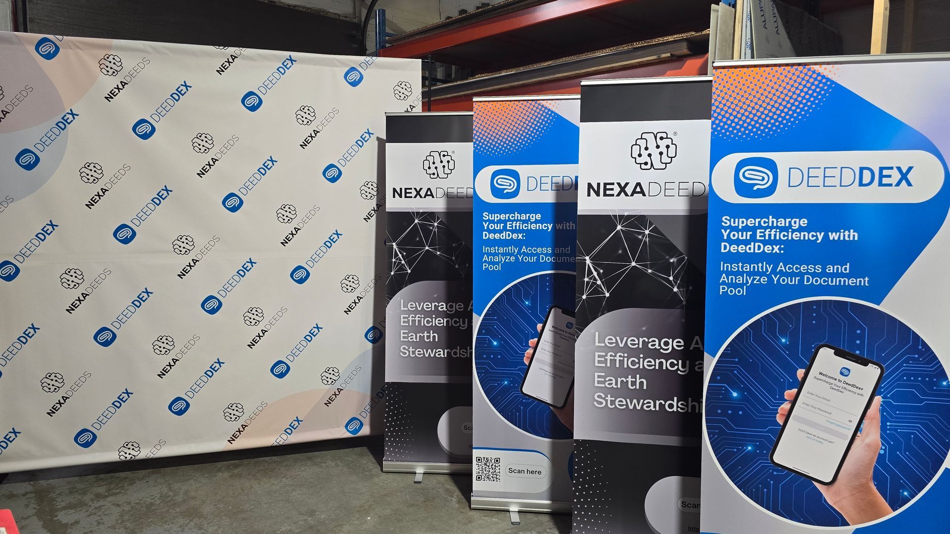 Trade show banners with the DEEDDEX logo and branding.