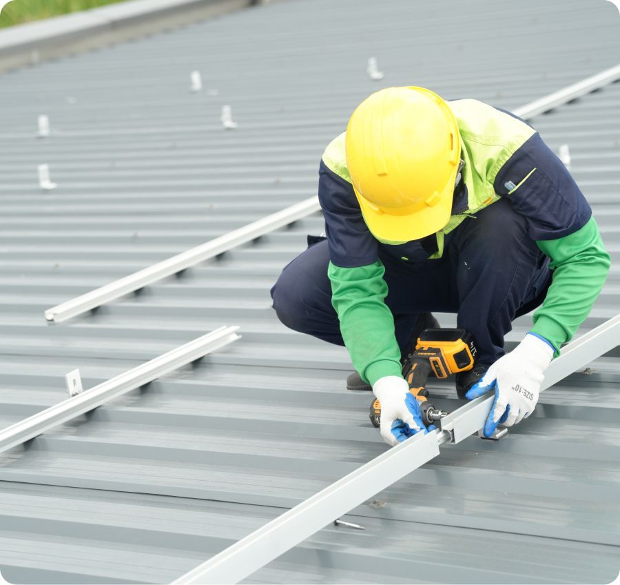 Roofer evaluating an existing roof before a metal roofing project
