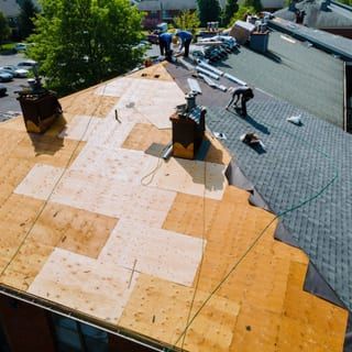 Roof Replacement in Florence, OR - roofing crew working on a low-slope roof