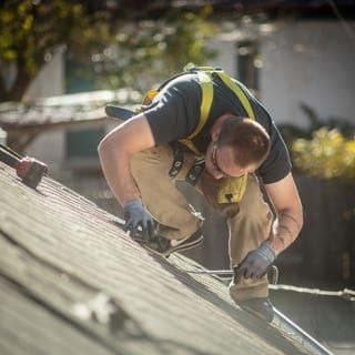 Roof Replacement in Florence, OR - roofer replacing shingles on a sloped roof