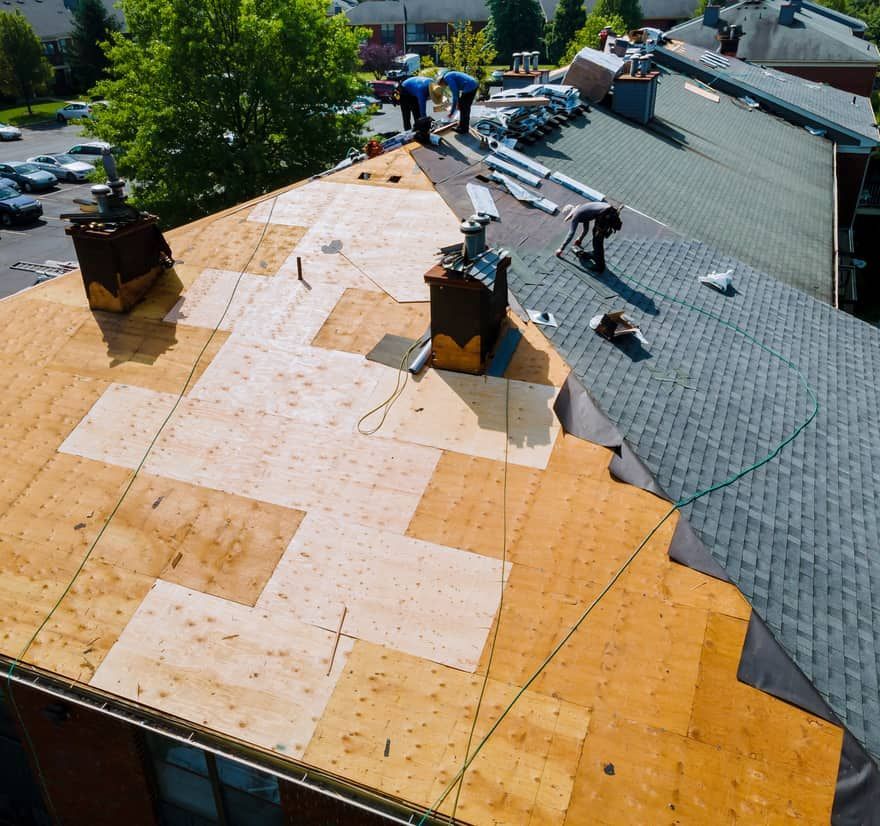 Roof Replacement in Florence, OR - roofing crew inspecting a roof deck from above