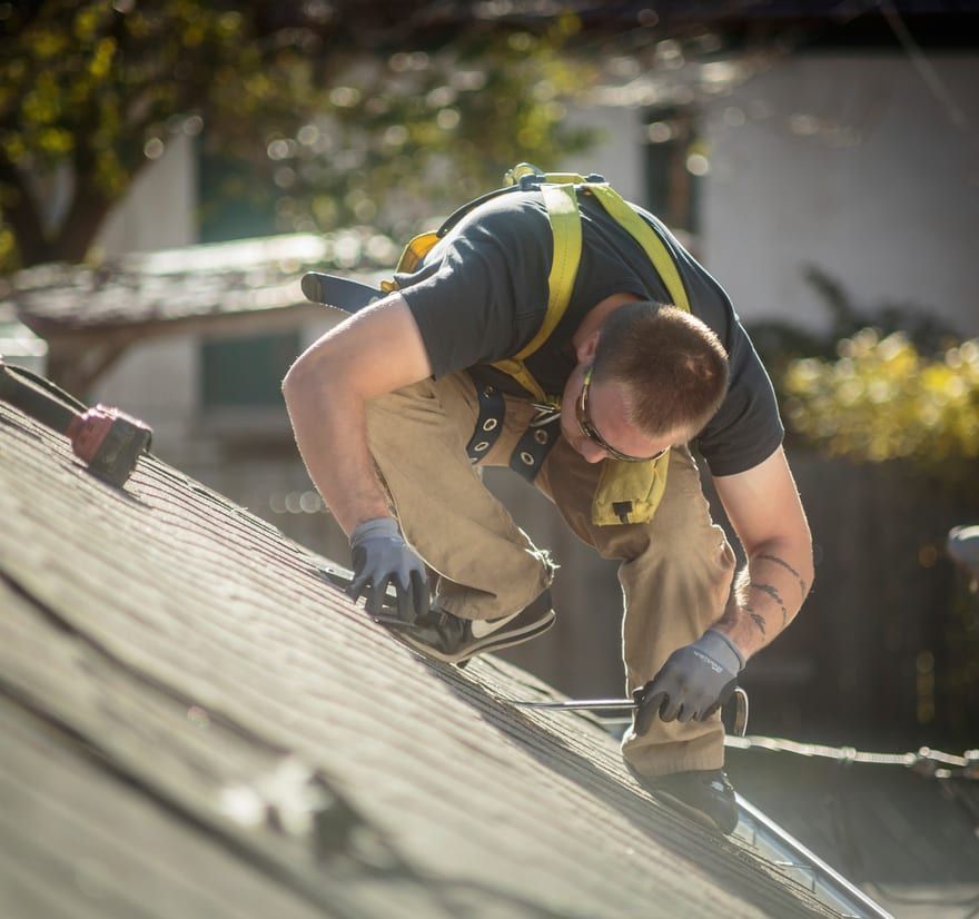 Roof Replacement in Florence, OR - roofer replacing shingles on a sloped roof