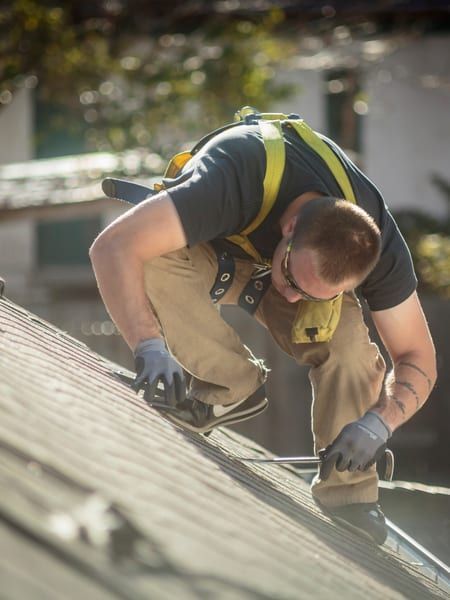 Roof Replacement in Florence, OR - roofer replacing shingles on a sloped roof