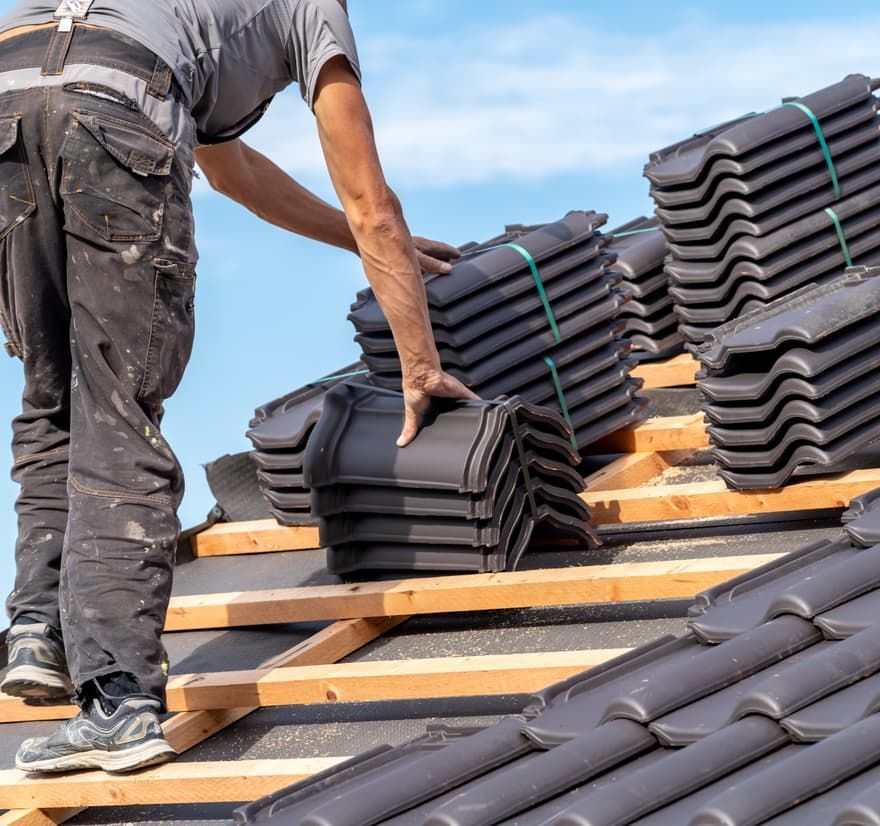 Roof Replacement in Florence, OR - roofer installing roof tiles