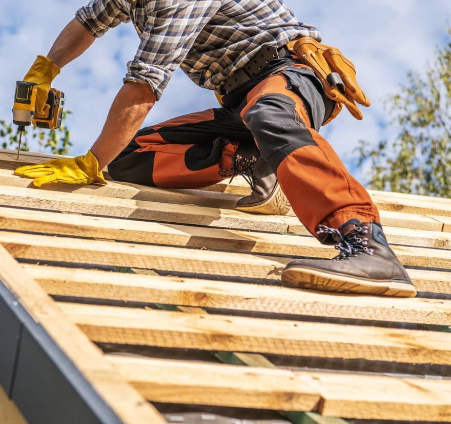 Roof Replacement in Waldport, OR - roofer driving screws into roof battens