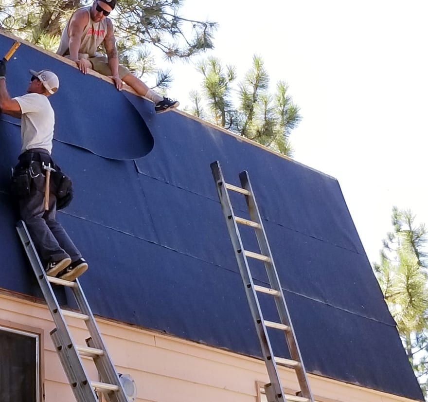 Roof Replacement in Yachats, OR - roofers installing underlayment on a house