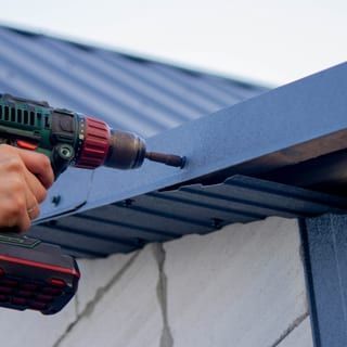 Roof Replacement in Yachats, OR - drill fastening metal roof trim