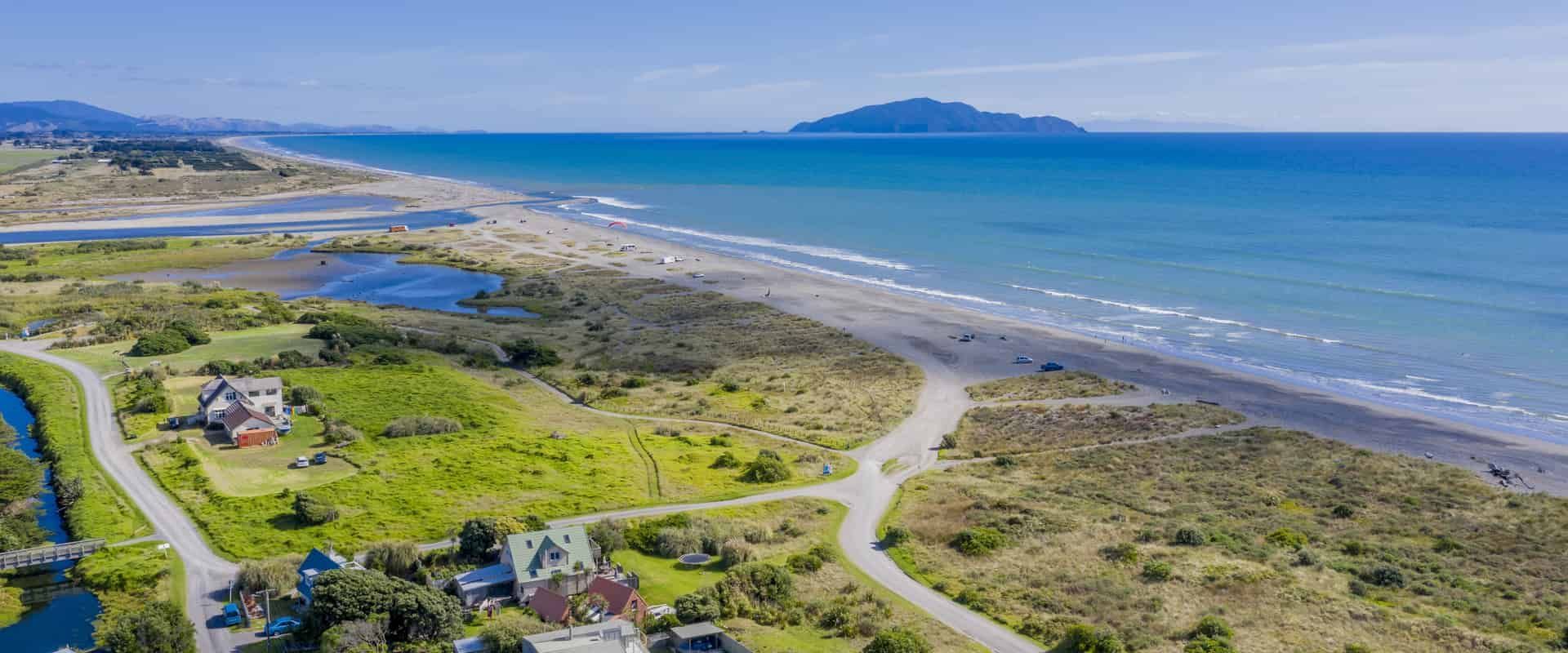 Roof Replacement in Yachats, OR - aerial view of a coastline and beach community