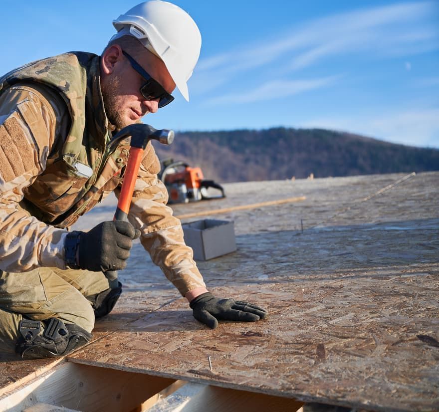 Roof Replacement in Yachats, OR - roofer hammering roof decking