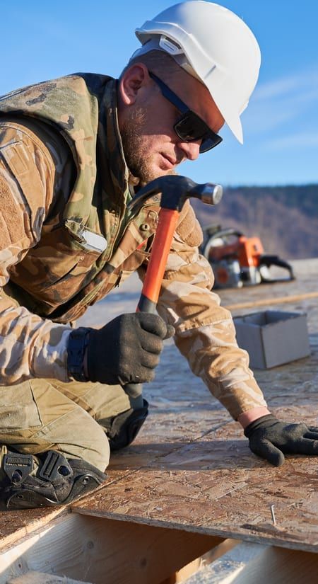 Roof Replacement in Yachats, OR - roofer hammering roof decking