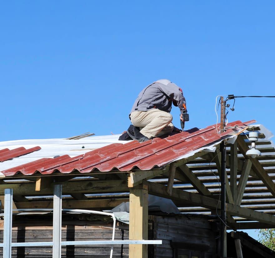 Roof Replacement in Yachats, OR - roofer installing roofing material on a house