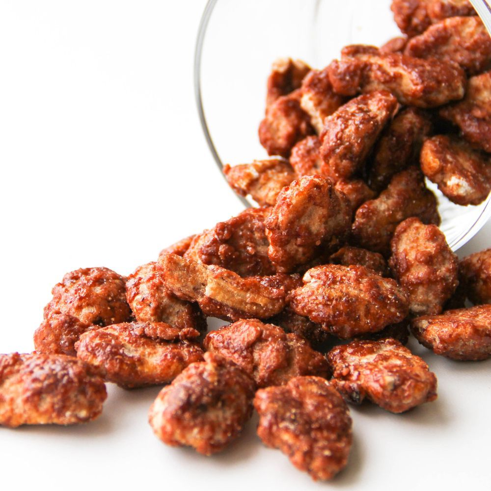 A glass filled with fried chicken is being poured on a table