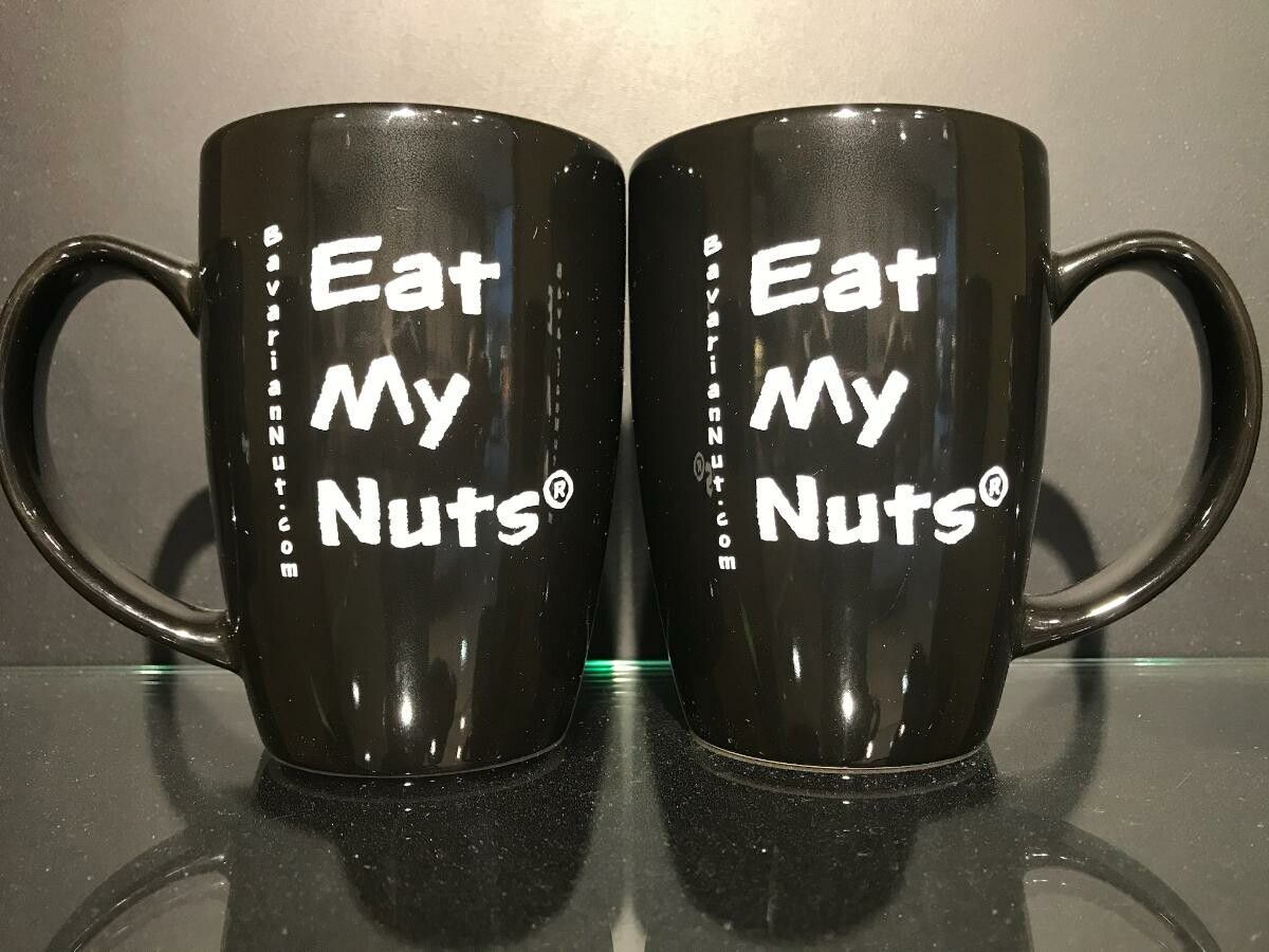 A pair of black mug with Eat My Nuts print