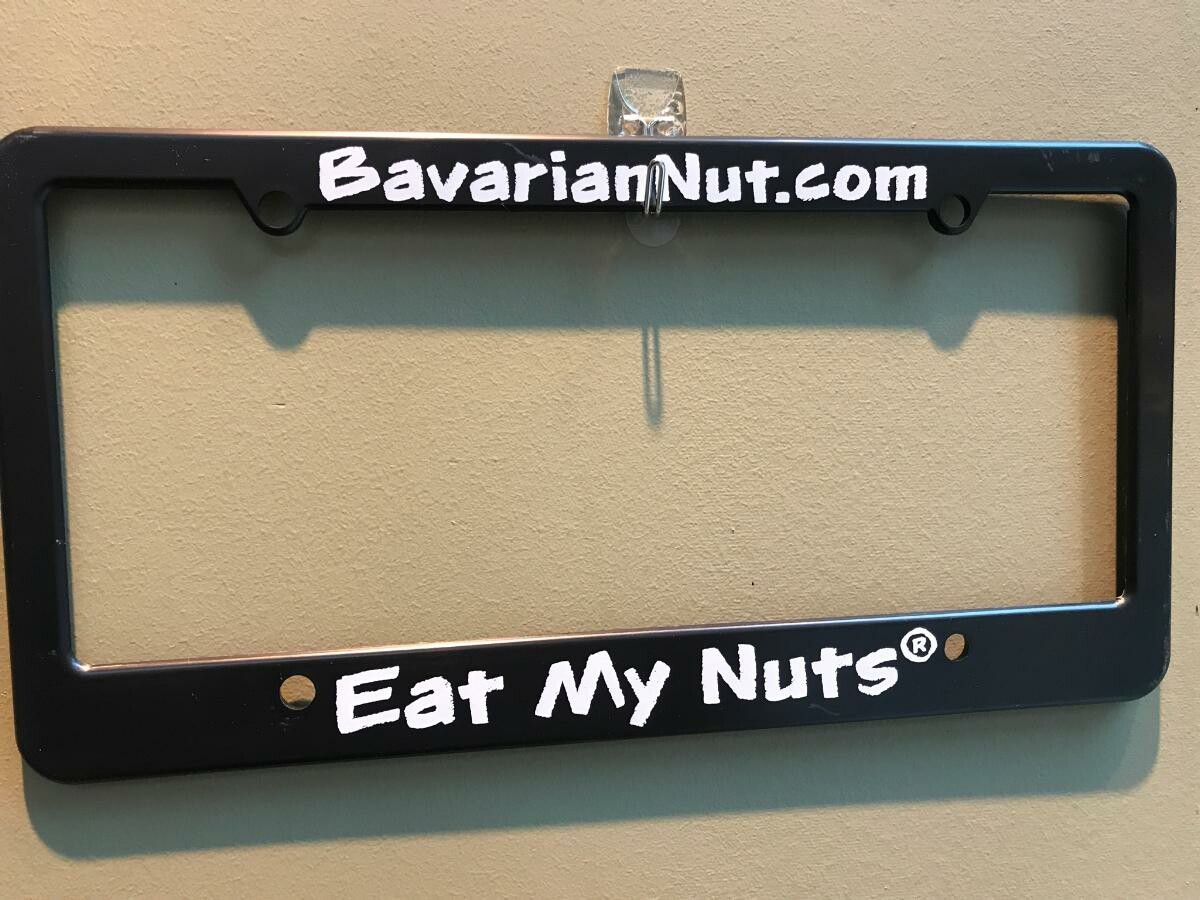 A black plate holder with with Eat My Nuts print