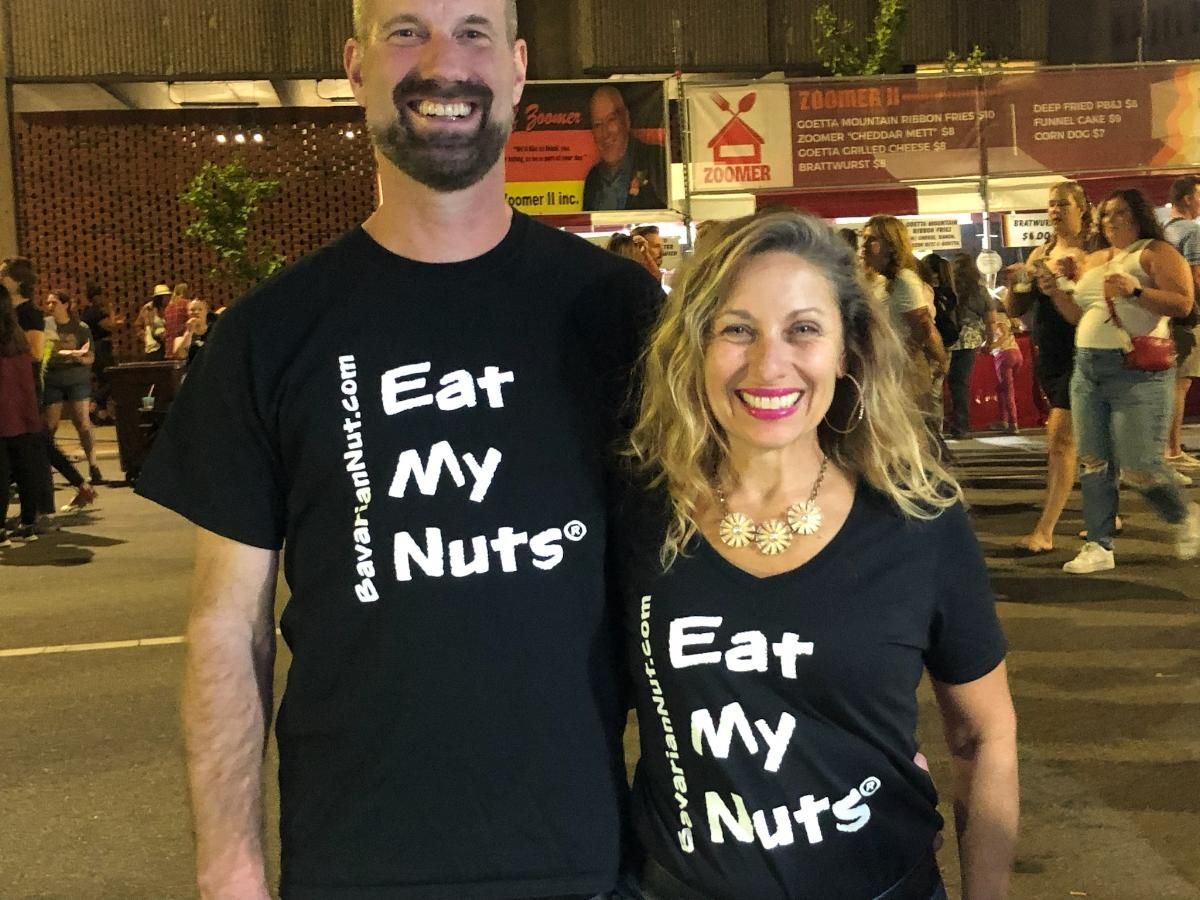 Man and a Woman wearing black t-shirt with Eat My Nuts print