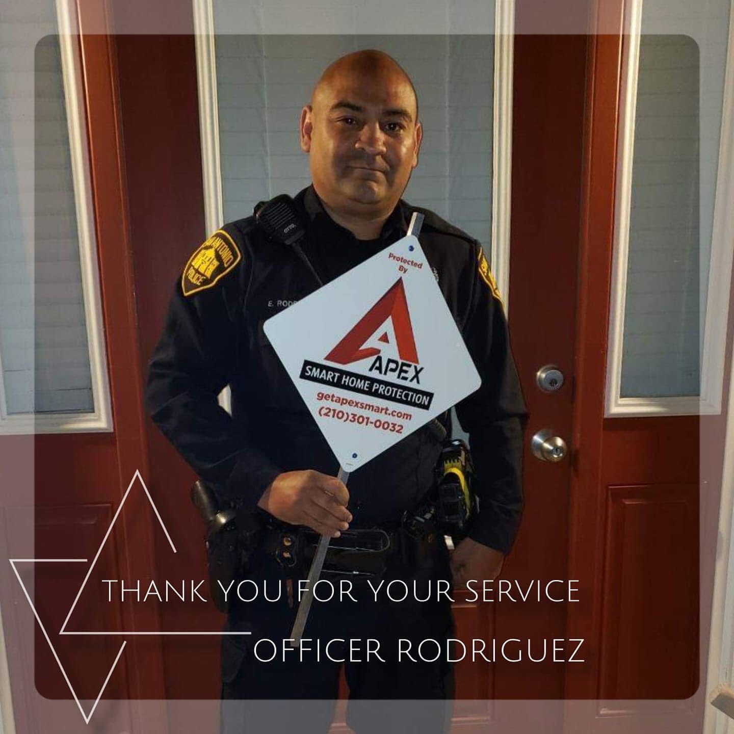 Police officer holding a thank-you sign, standing in a doorway with “Thank You for Your Service, Officer Rodriguez” text.