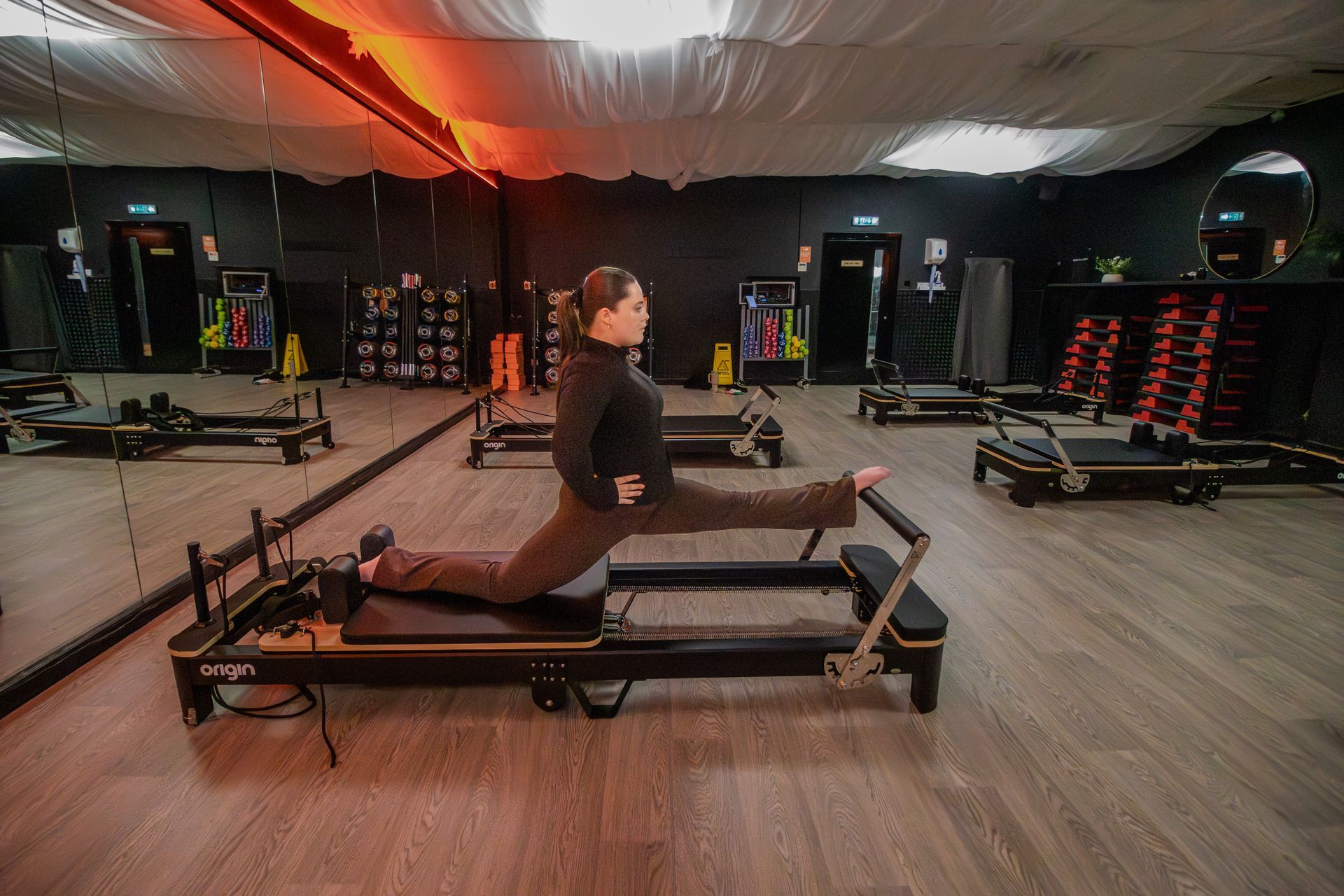 Member on a reformer in the Reformer Pilates studio at Fervid Fitness Runcorn