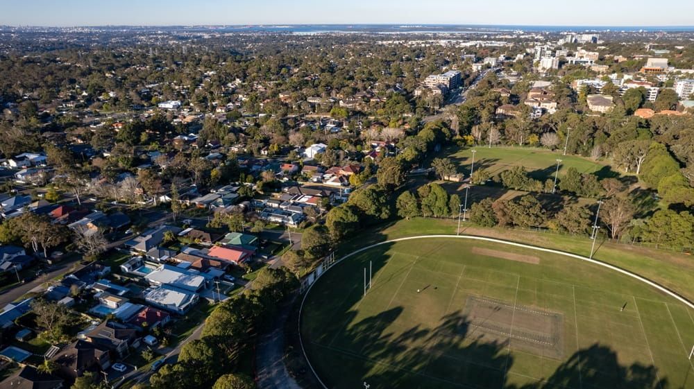 An Aerial View of A Residential Area with A Soccer Field in The Middle — Brookes Engraving & Signs in Southern Highlands, NSW