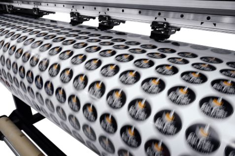 A Machine that Is Printing Stickers on A Roll — Brookes Engraving & Signs in Wollongong, NSW