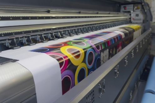 A Large Printer Is Printing a Large Piece of Paper — Brookes Engraving & Signs in Wollongong, NSW