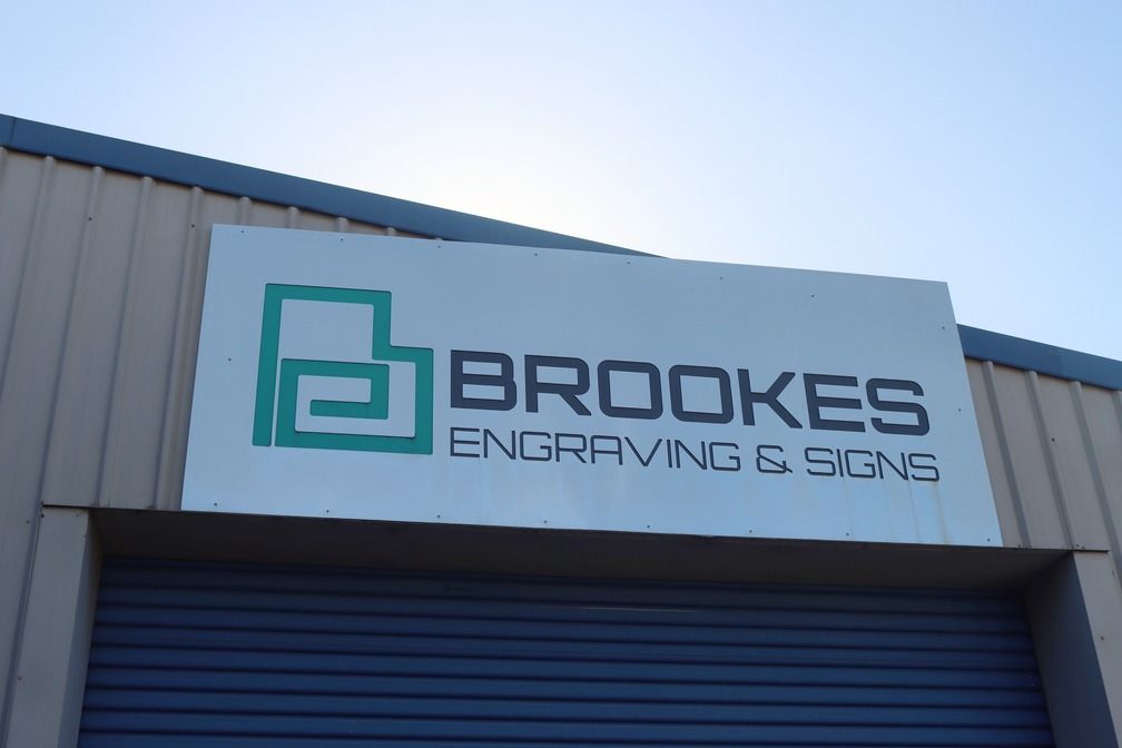 Store Signage on warehouse — Brookes Engraving & Signs in Woonona, NSW