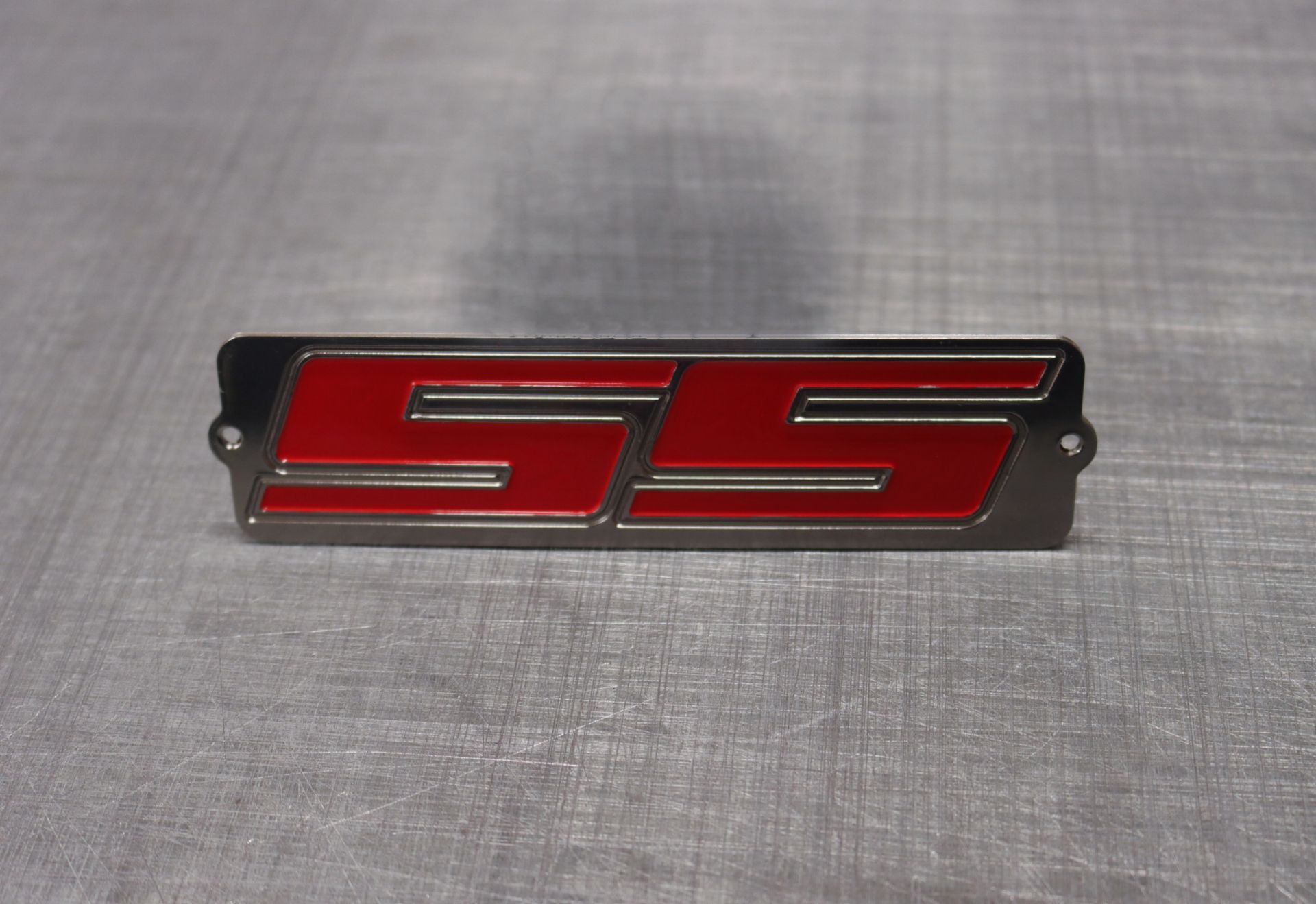 A red and black emblem with the letter s on it 