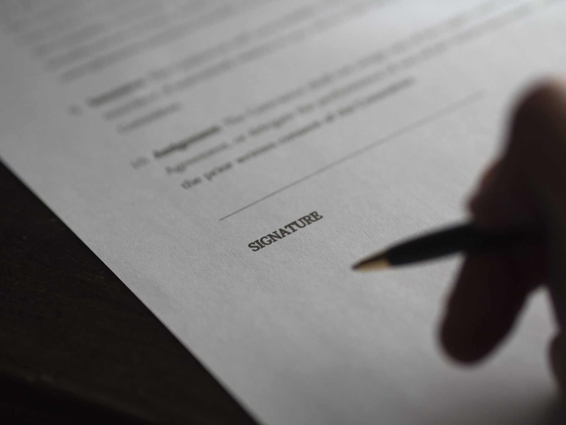 A person signing a housing contract.