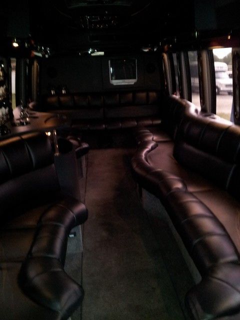 A dark room with a couch and chairs in it