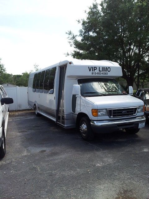 A white vip limo is parked in a parking lot