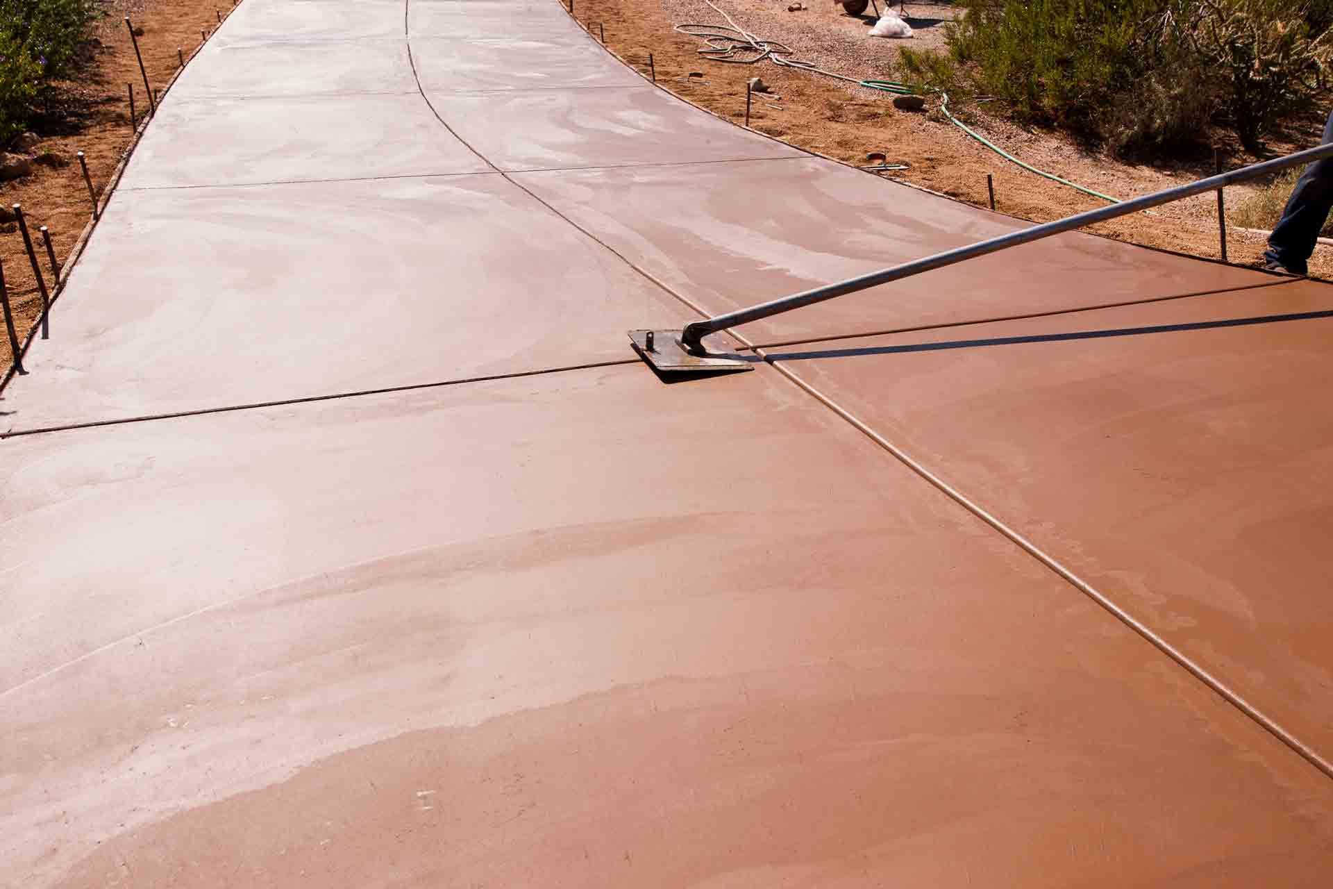 Worker Smoothing Concrete on a New Driveway Construction Project | Townsville, Qld | North Queensland Concrete Solutions