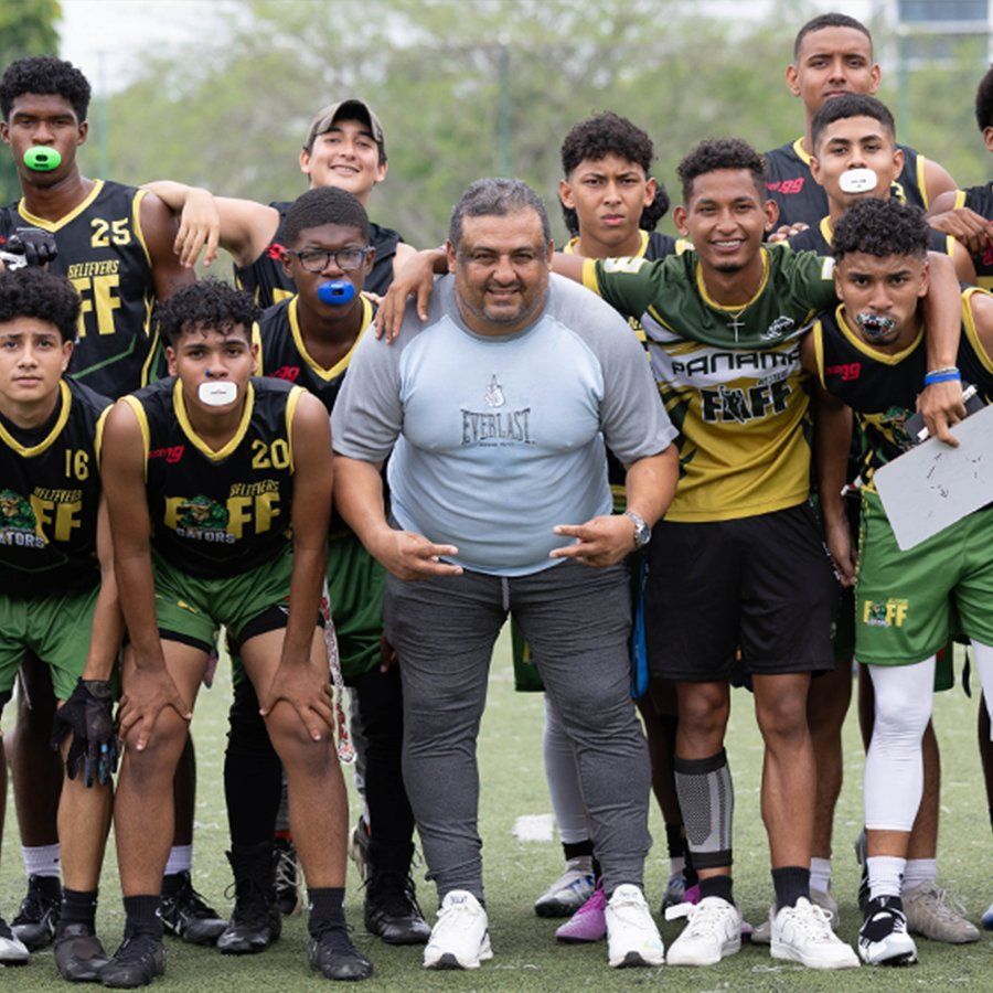 Coach and young Believers athletes posing together