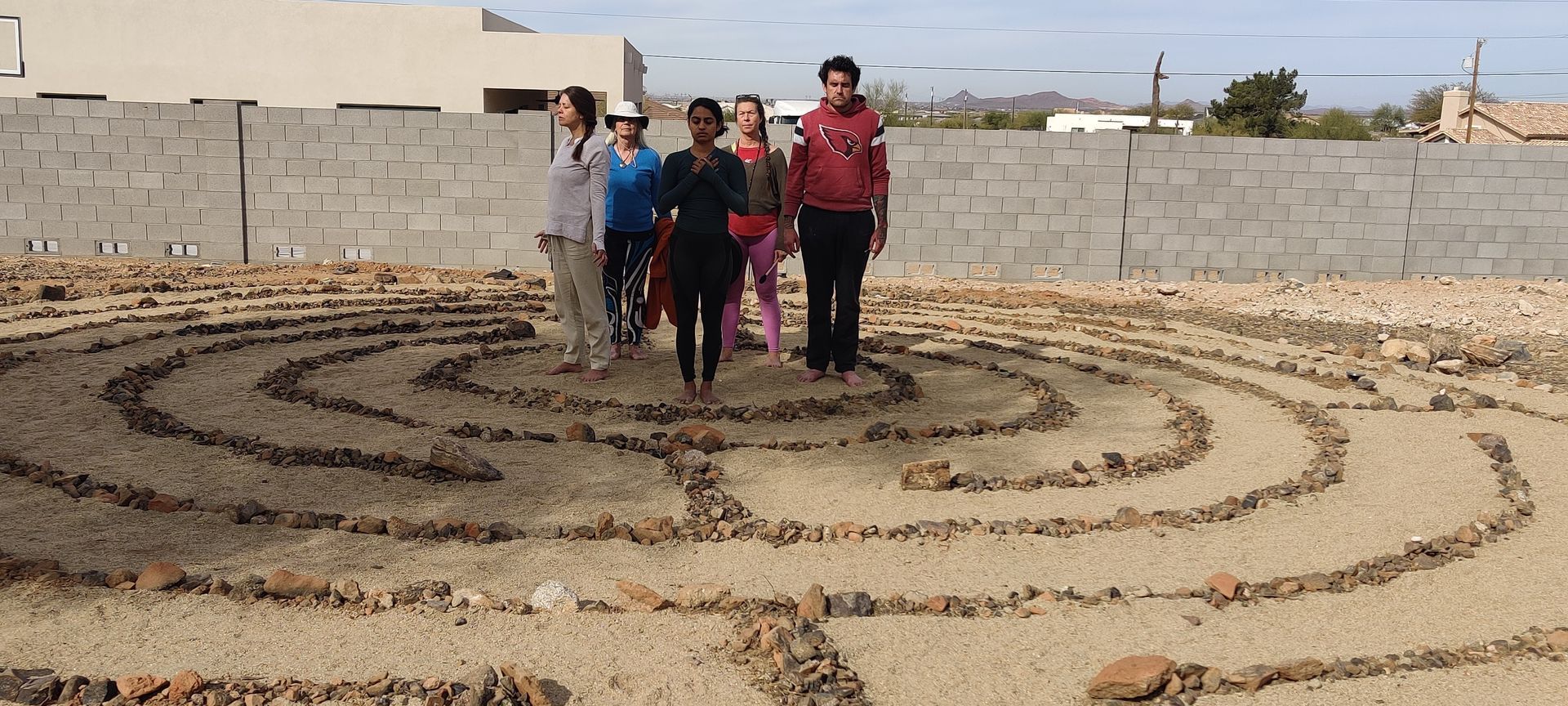 A group of people are standing in a labyrinth.
