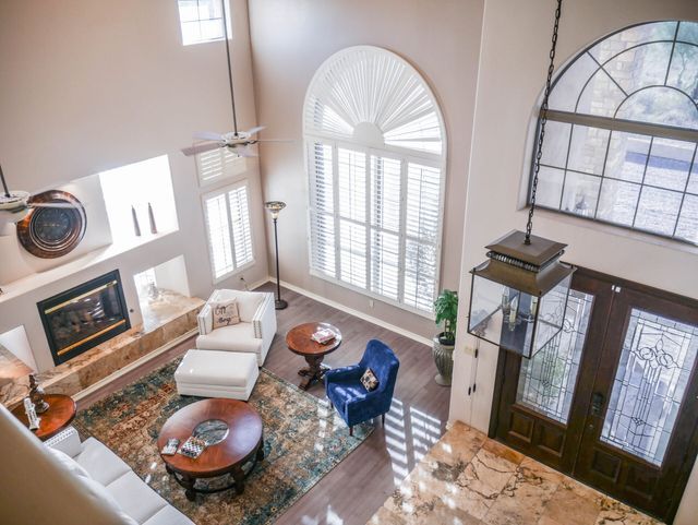 An aerial view of a living room filled with furniture and a fireplace.
